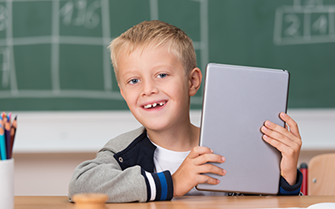 Boy with tablet in classroom